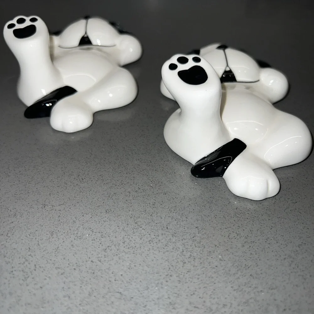 Two black-and-white dog wall hooks